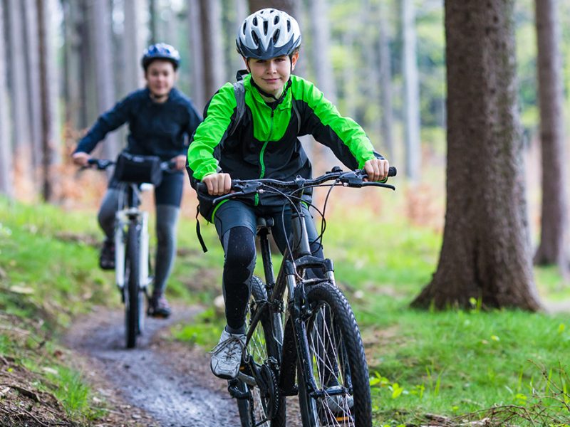 Healthy lifestyle - teenage girl and boy biking